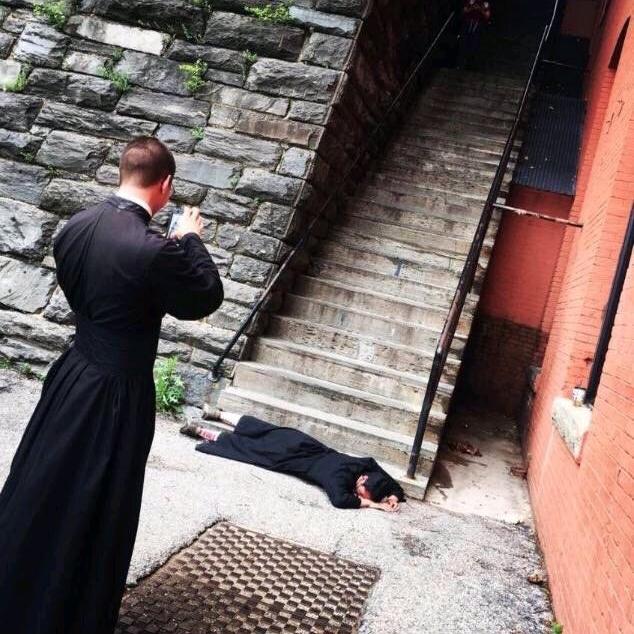 Ordained Exorcists snapping photos at The Exorcist steps.