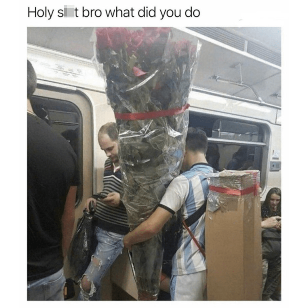 man holding extremely large bouquet on train